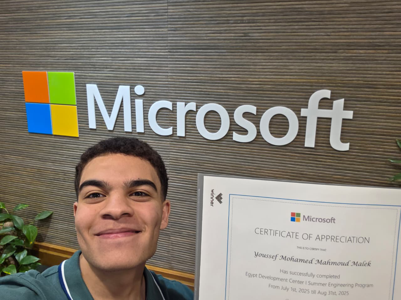 Youssef Malek holding his certificate at the Microsoft Egypt Development Center